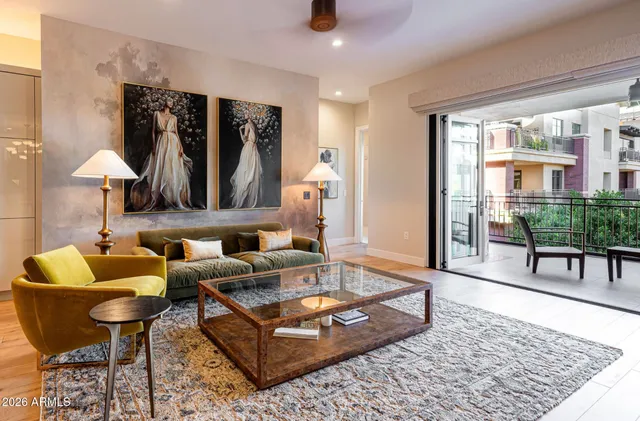 a living room with furniture a lamp and a rug