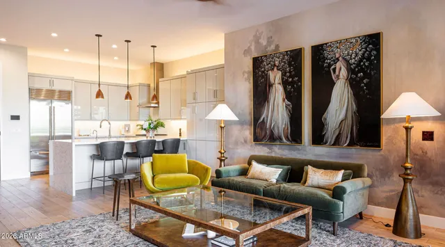 a living room with furniture a rug and a chandelier