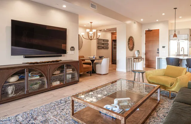 a living room with a couch and chandelier