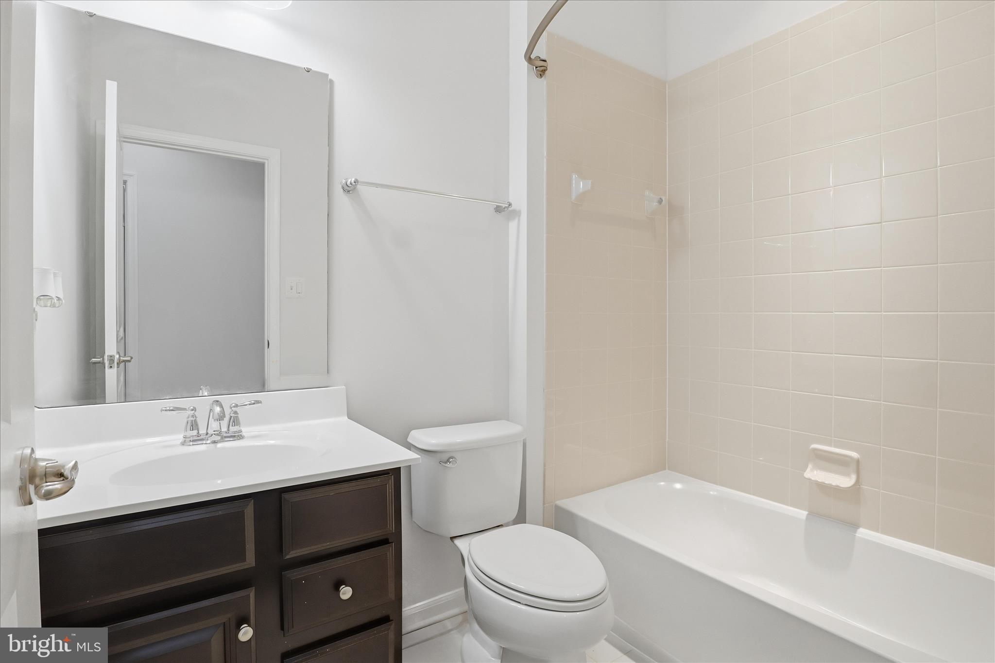 7455 Brunson Circle Gainesville, VA 20155 - Photo 23 of 41 a bathroom with a sink a toilet and shower