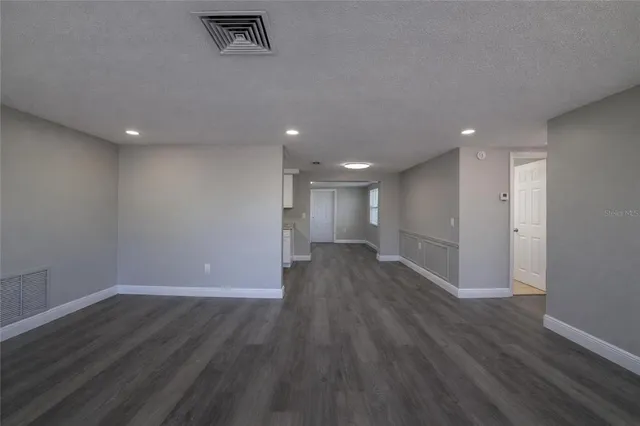 a view of a room with wooden floor and window