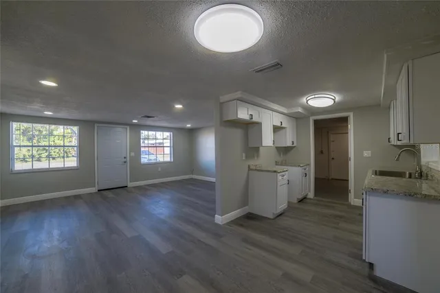 a kitchen with a refrigerator and a stove top oven