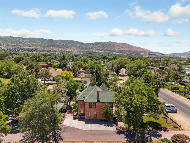 12825 South Fort Street Draper, UT 84020 - Photo 51 of 52 Brick exterior structure featuring a green shingle roof and a prominent turret