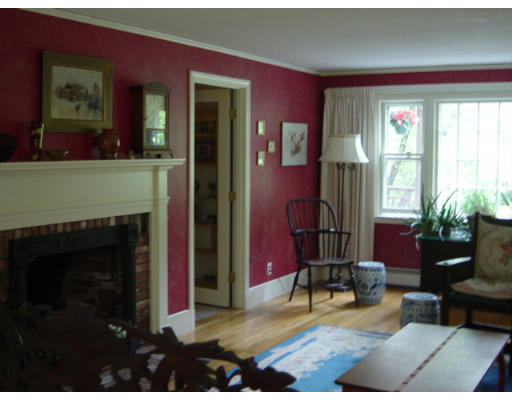79 Bare Hill Road Bolton, MA 01740 - Photo 3 of 12 a living room with furniture a fireplace and a floor to ceiling window