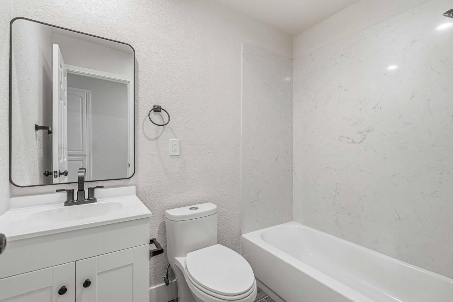 1464 Denise Drive Ripon, CA 95366 - Photo 17 of 41 a bathroom with a toilet a sink a mirror and vanity