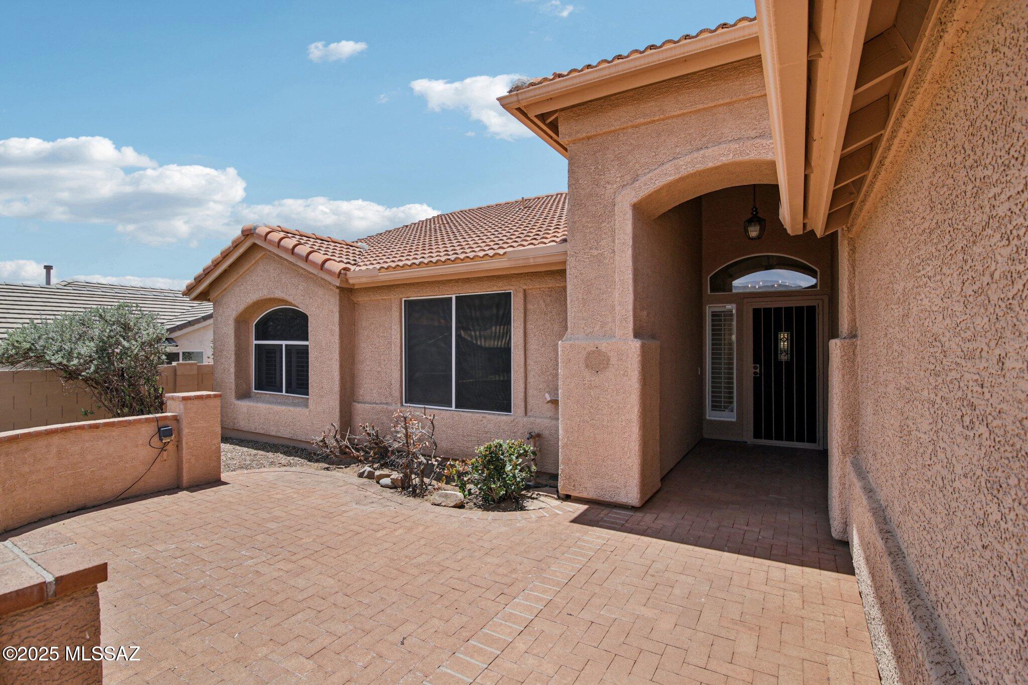 35890 Mesa Ridge Drive Tucson, AZ 85739 - Photo 2 of 31 a front view of a house with garden