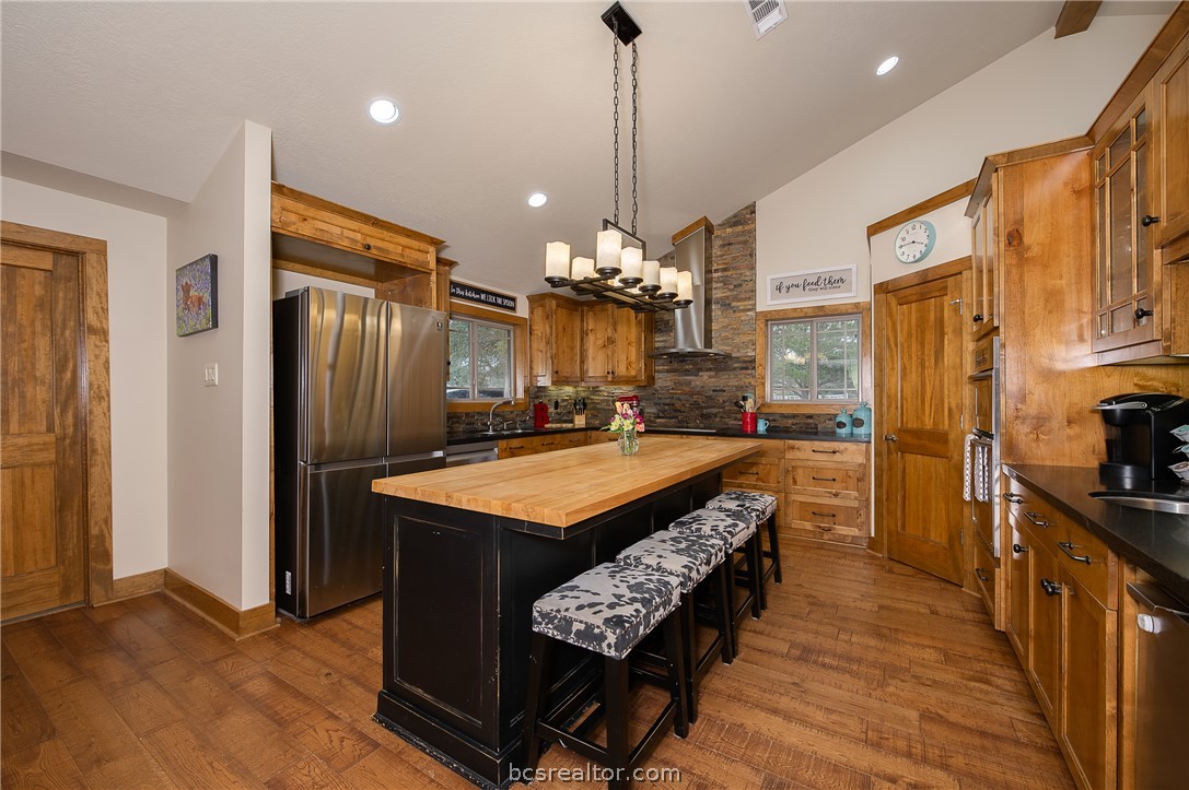 2302 Quail Run College Station, TX 77845 - Photo 10 of 49 a kitchen with refrigerator and wooden floor