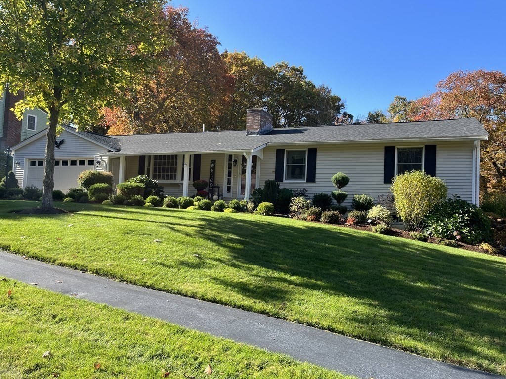 a front view of house with yard and green space