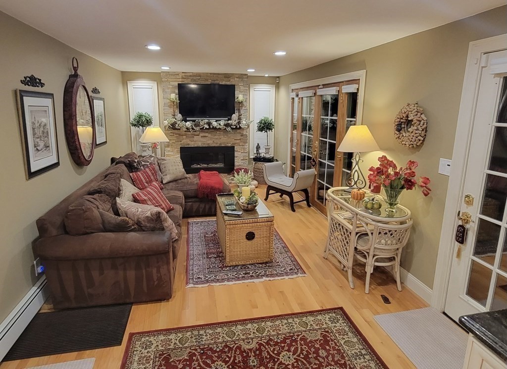 27 Mark Circle Holden, MA 01520 - Photo 13 of 39 a living room with furniture a flat screen tv and a fireplace