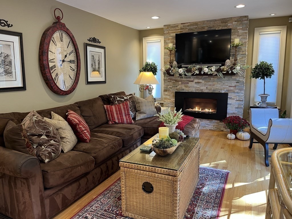 27 Mark Circle Holden, MA 01520 - Photo 14 of 39 a living room with furniture a flat screen tv and a fireplace