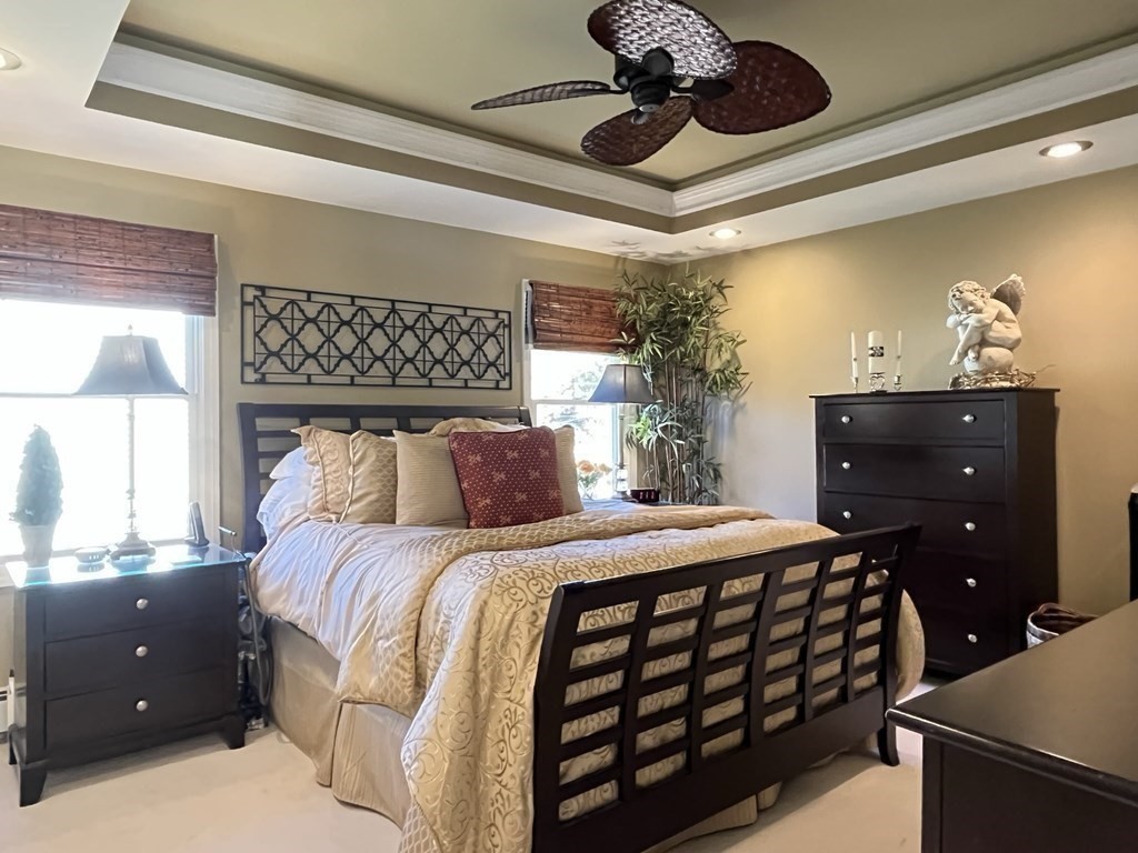 27 Mark Circle Holden, MA 01520 - Photo 15 of 39 a bedroom with a bed and a chandelier