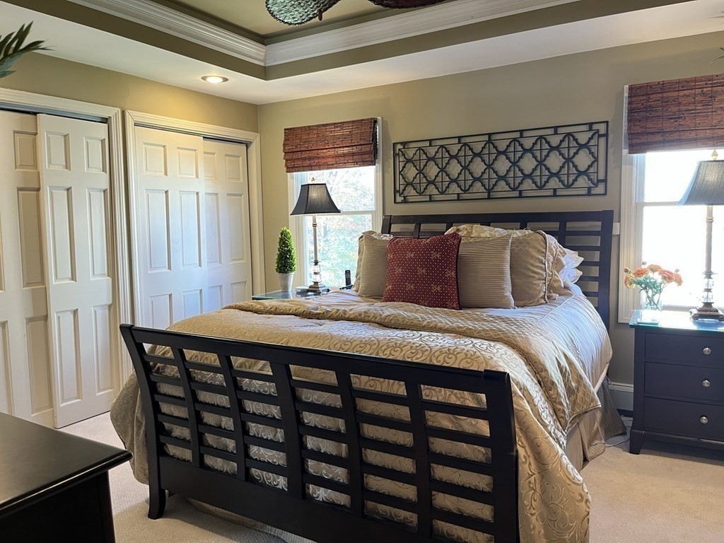 27 Mark Circle Holden, MA 01520 - Photo 16 of 39 a bedroom with a bed and wooden floor