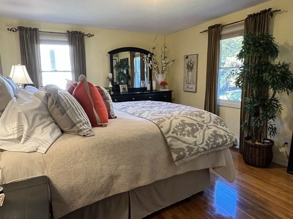 27 Mark Circle Holden, MA 01520 - Photo 19 of 39 a bedroom with a bed and a potted plant