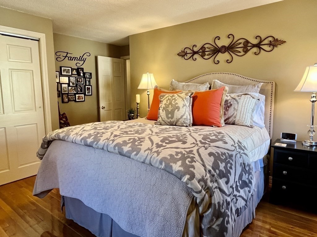 27 Mark Circle Holden, MA 01520 - Photo 20 of 39 a bedroom with a large bed and a dresser