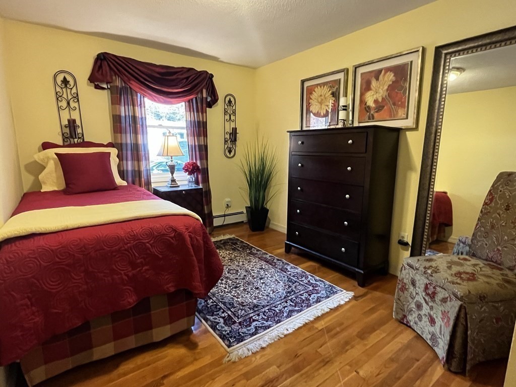 27 Mark Circle Holden, MA 01520 - Photo 21 of 39 a bedroom with a bed and wooden floor