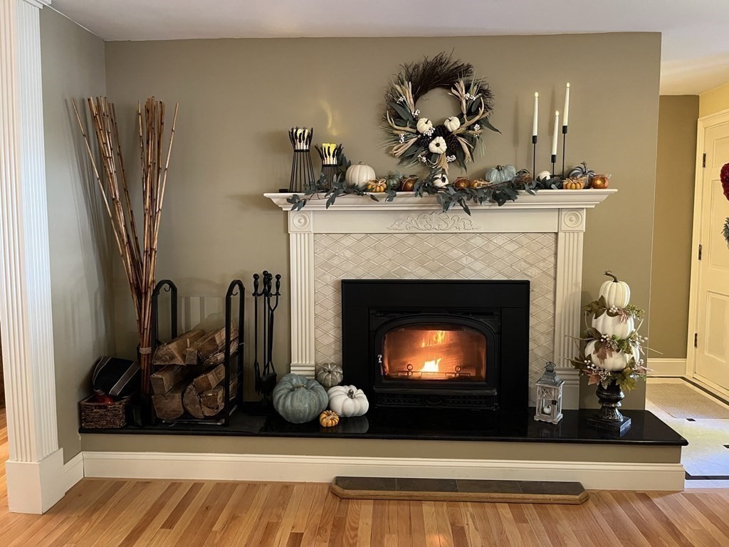 27 Mark Circle Holden, MA 01520 - Photo 6 of 39 a living room with furniture a fireplace and potted plants