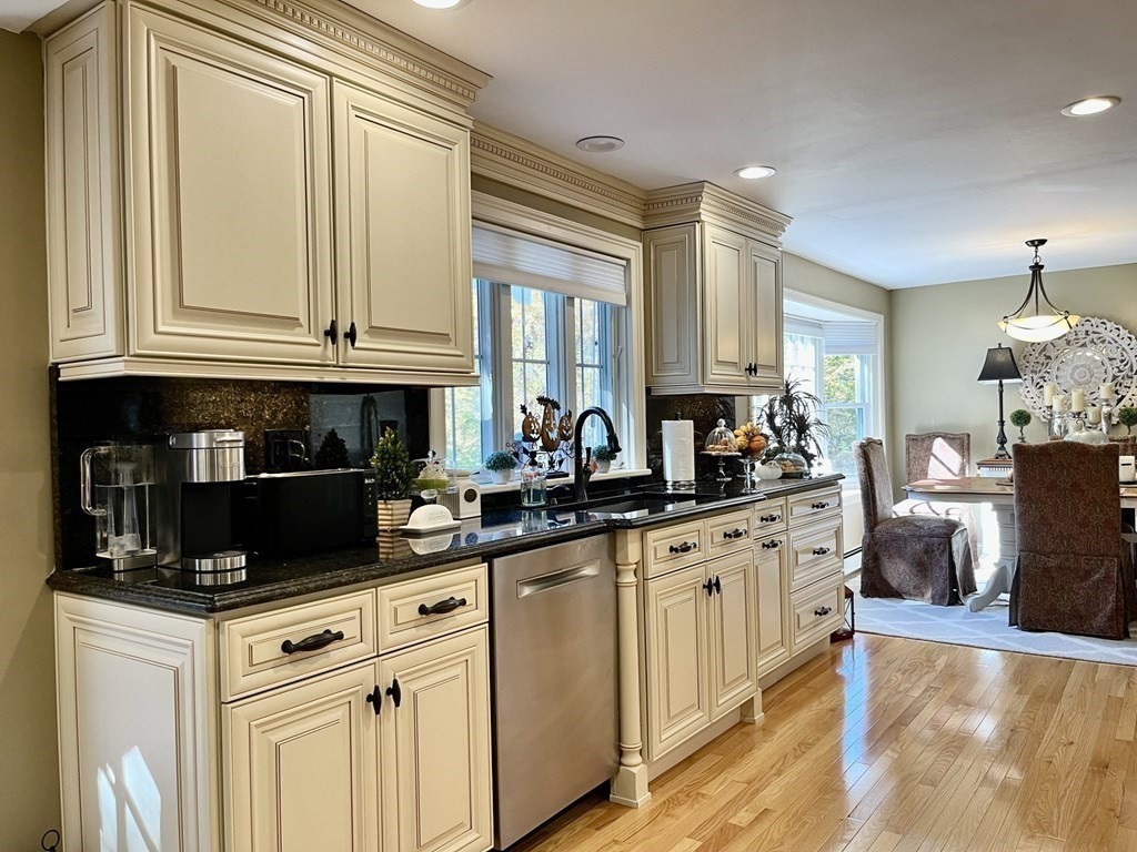 27 Mark Circle Holden, MA 01520 - Photo 9 of 39 a kitchen with stainless steel appliances granite countertop a stove a sink and white cabinets
