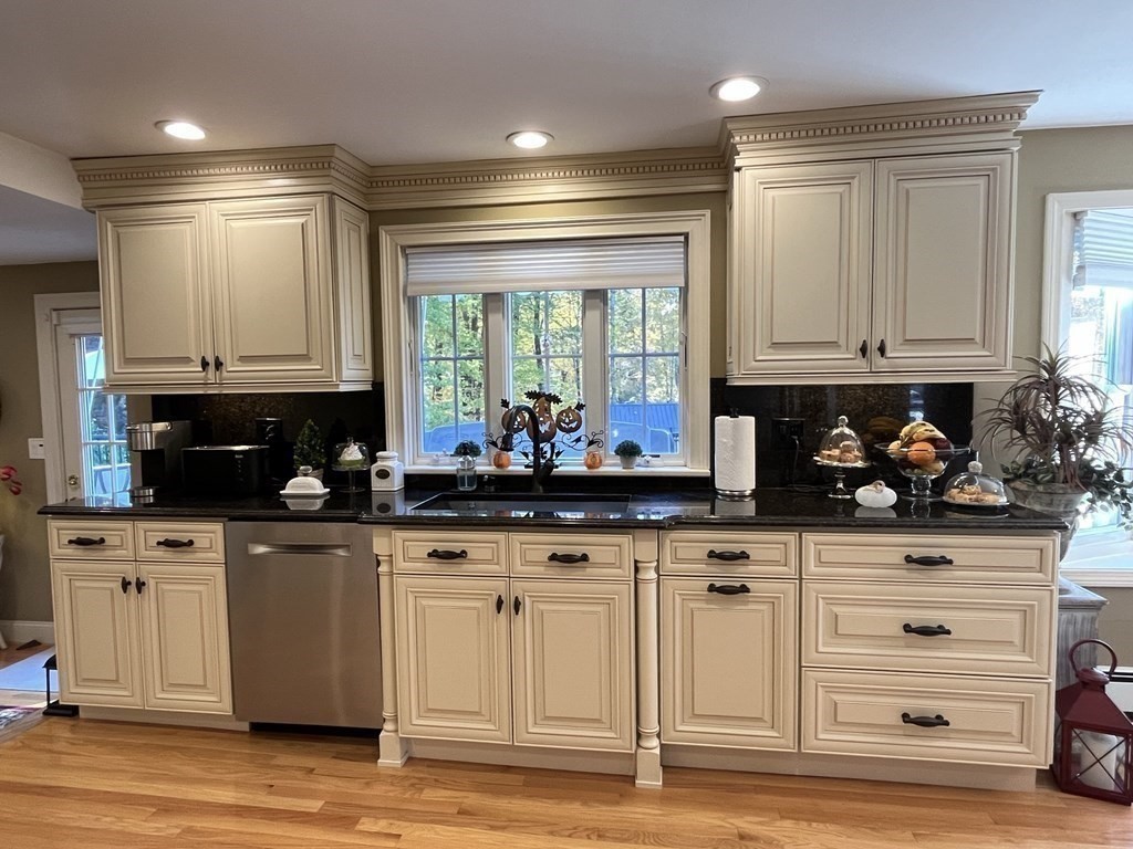 27 Mark Circle Holden, MA 01520 - Photo 10 of 39 a kitchen with granite countertop a stove a sink and a cabinets