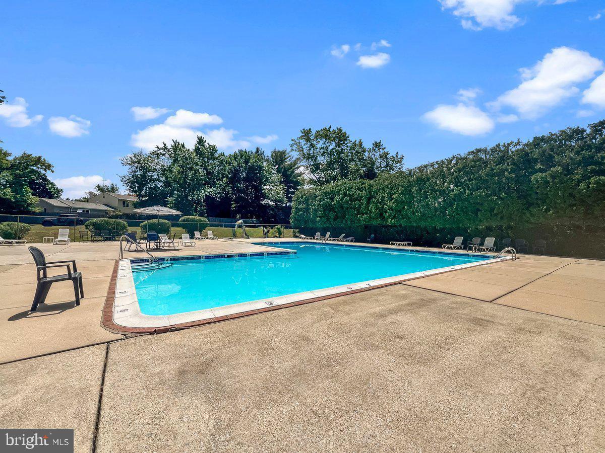 336 Saybrook Lane Wallingford, PA 19086 - Photo 20 of 22 a view of a swimming pool with a yard and plants