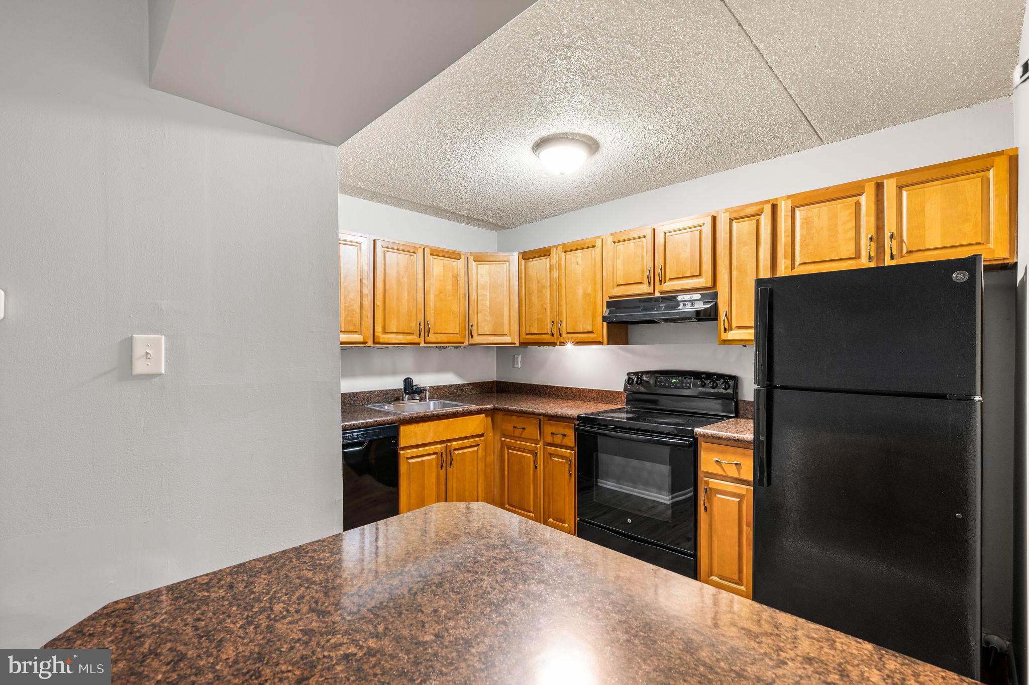 336 Saybrook Lane Wallingford, PA 19086 - Photo 7 of 22 a kitchen with stainless steel appliances granite countertop a refrigerator a sink dishwasher a stove top oven a refrigerator and cabinets