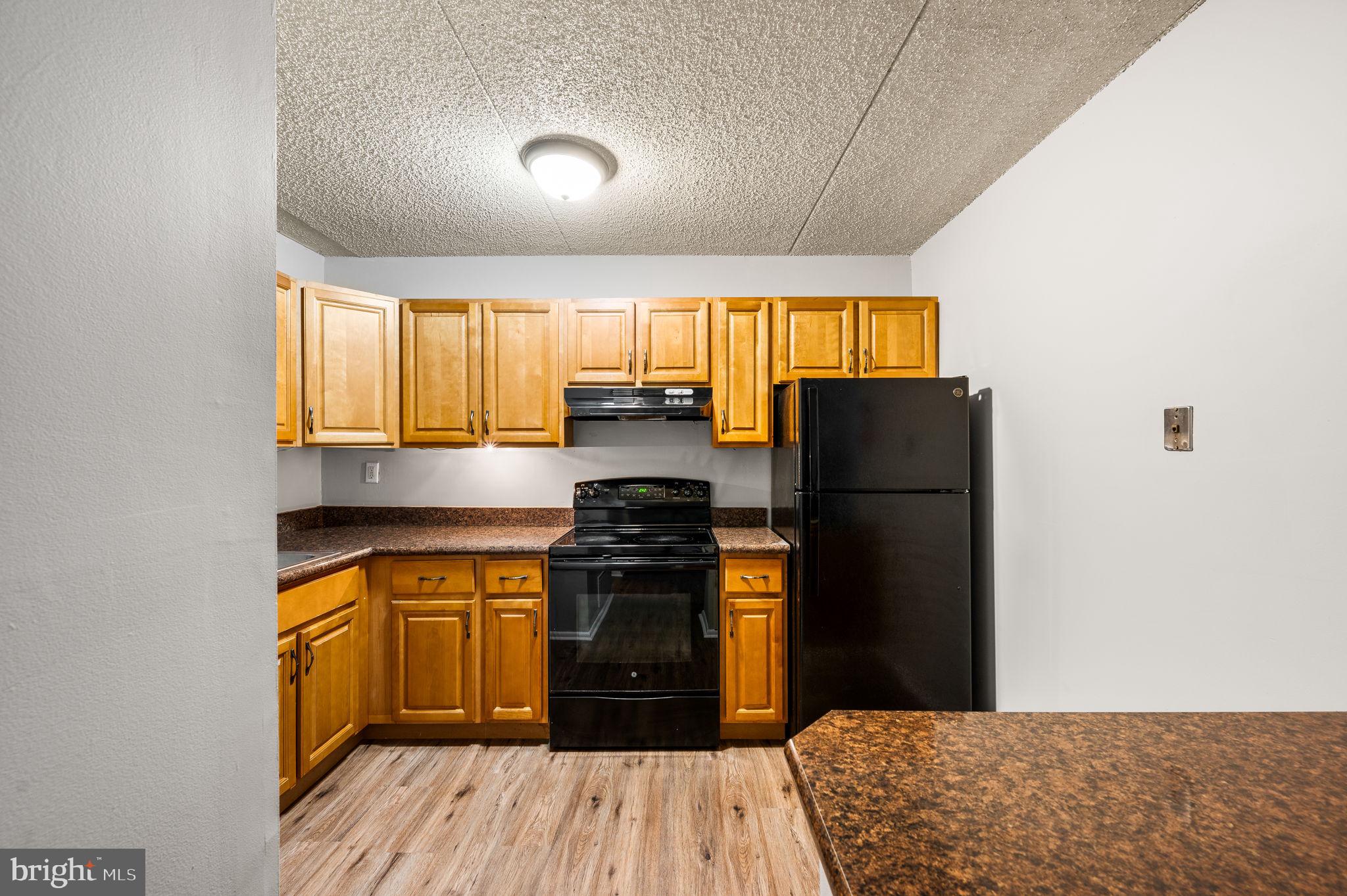 336 Saybrook Lane Wallingford, PA 19086 - Photo 8 of 22 a kitchen with granite countertop a refrigerator stove and sink