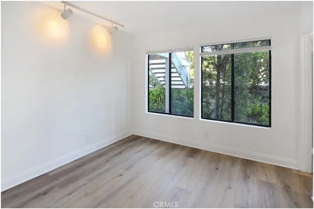 a view of an empty room with glass door