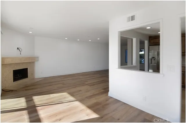 a kitchen with a refrigerator sink and cabinets