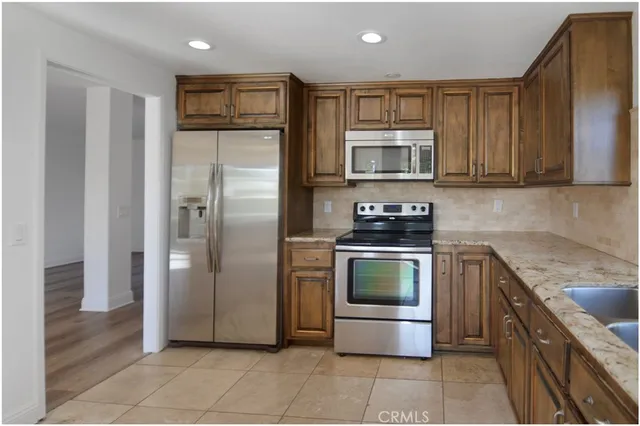 a kitchen with a sink and a refrigerator