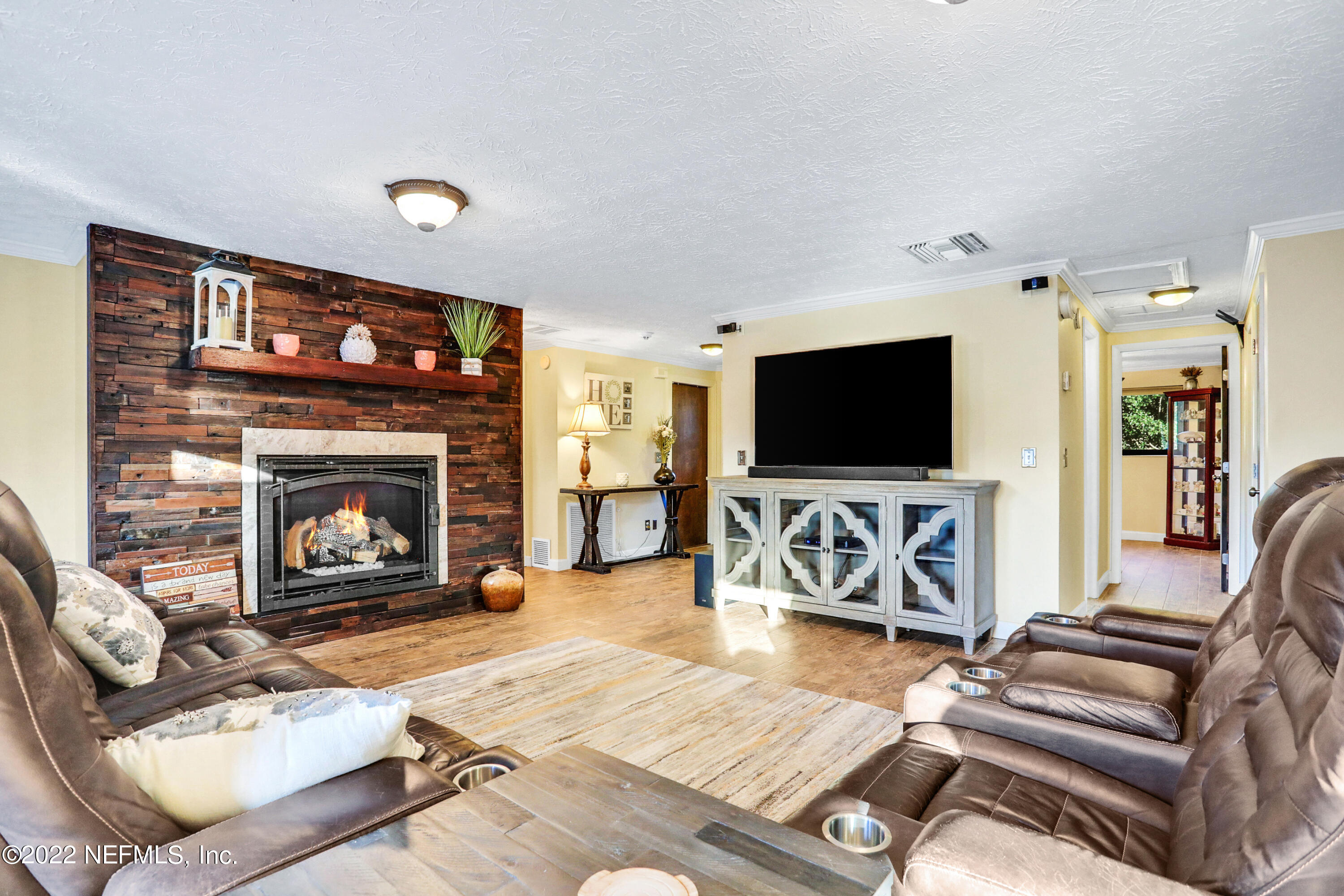 2198 Carter Braxton Road Orange Park, FL 32073 - Photo 15 of 33 a living room with furniture a flat screen tv and a fireplace