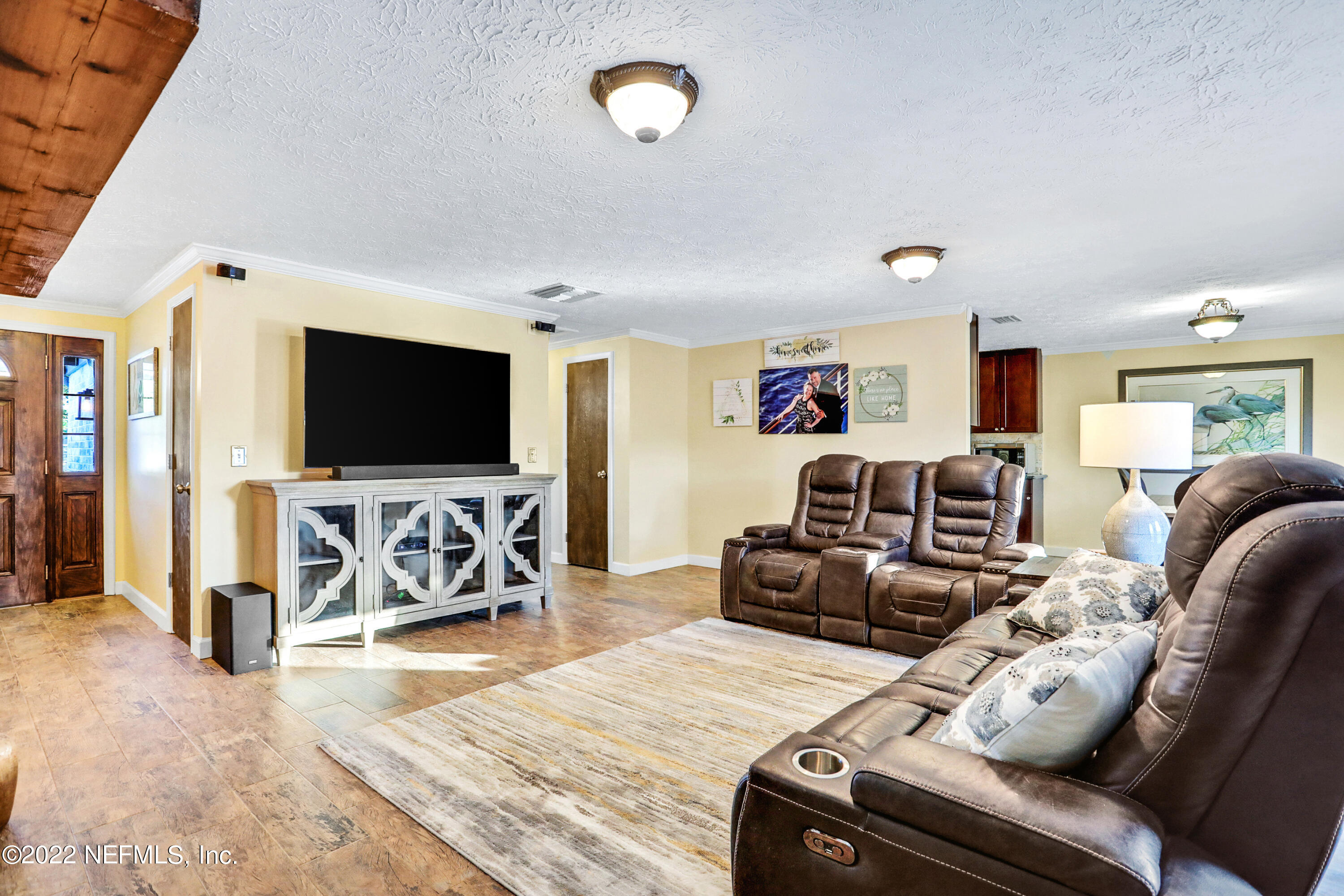 2198 Carter Braxton Road Orange Park, FL 32073 - Photo 16 of 33 a living room with furniture and a flat screen tv