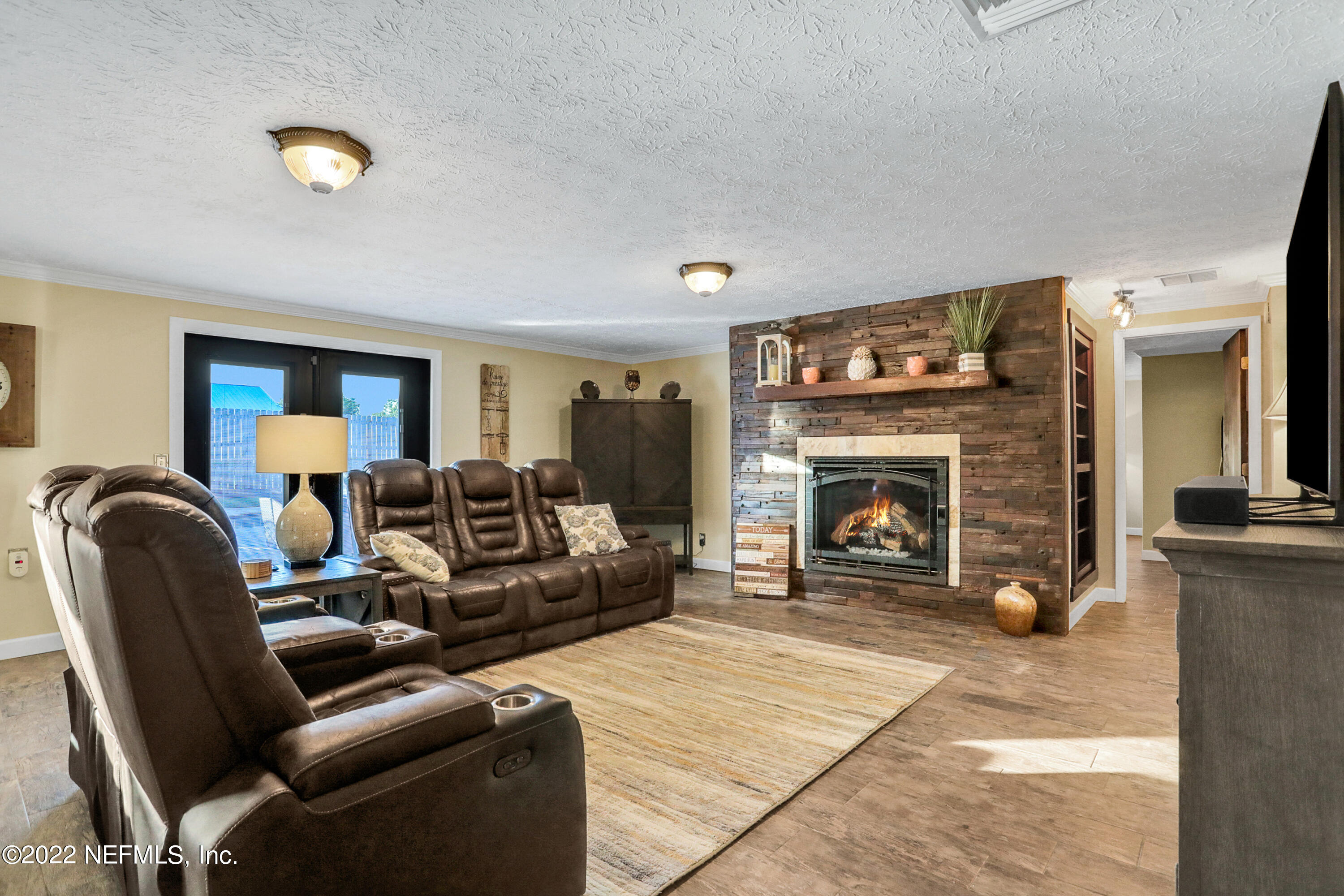 2198 Carter Braxton Road Orange Park, FL 32073 - Photo 17 of 33 a living room with furniture and a fireplace