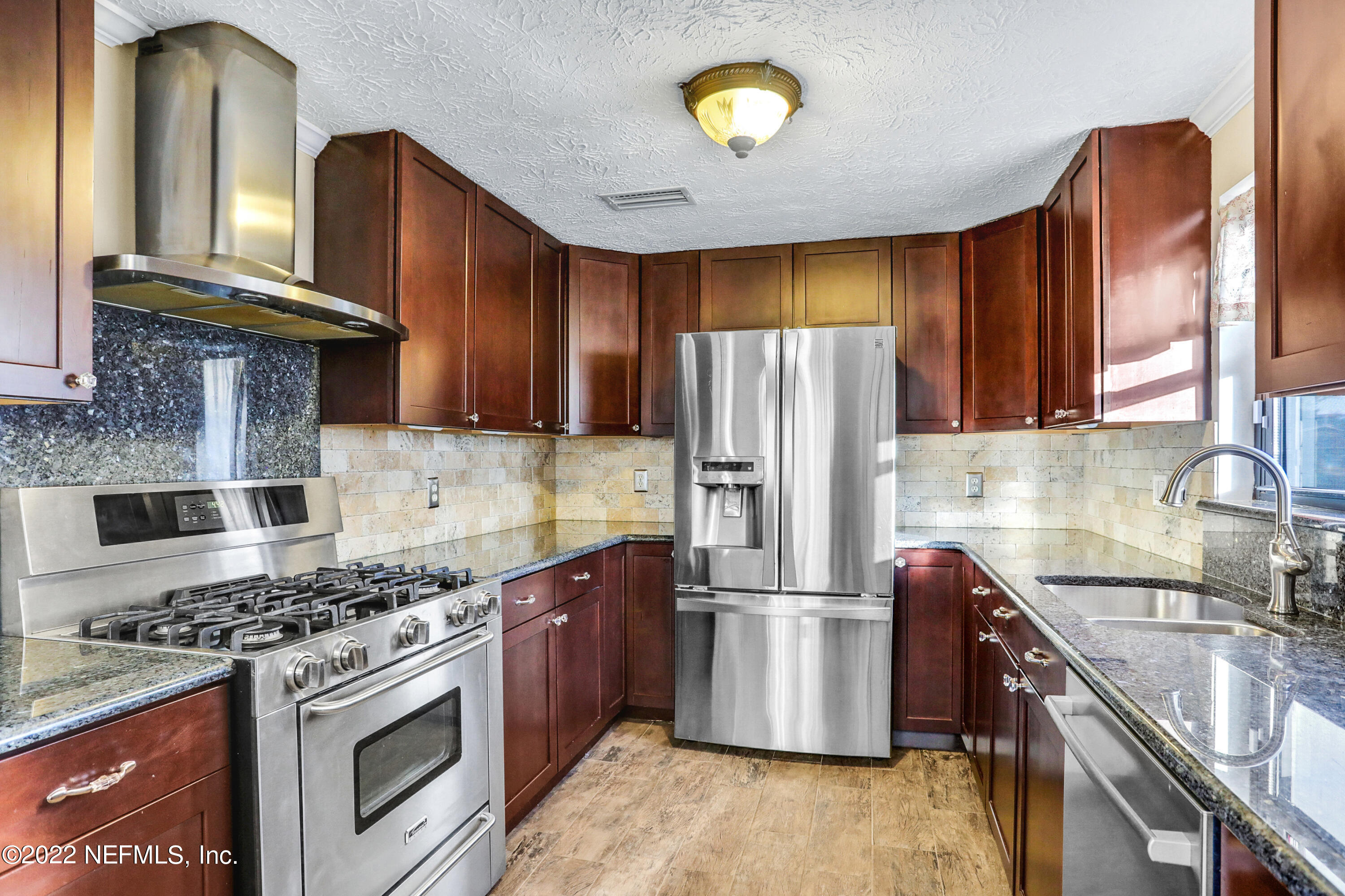 2198 Carter Braxton Road Orange Park, FL 32073 - Photo 22 of 33 a kitchen with stainless steel appliances granite countertop a stove a refrigerator and a sink