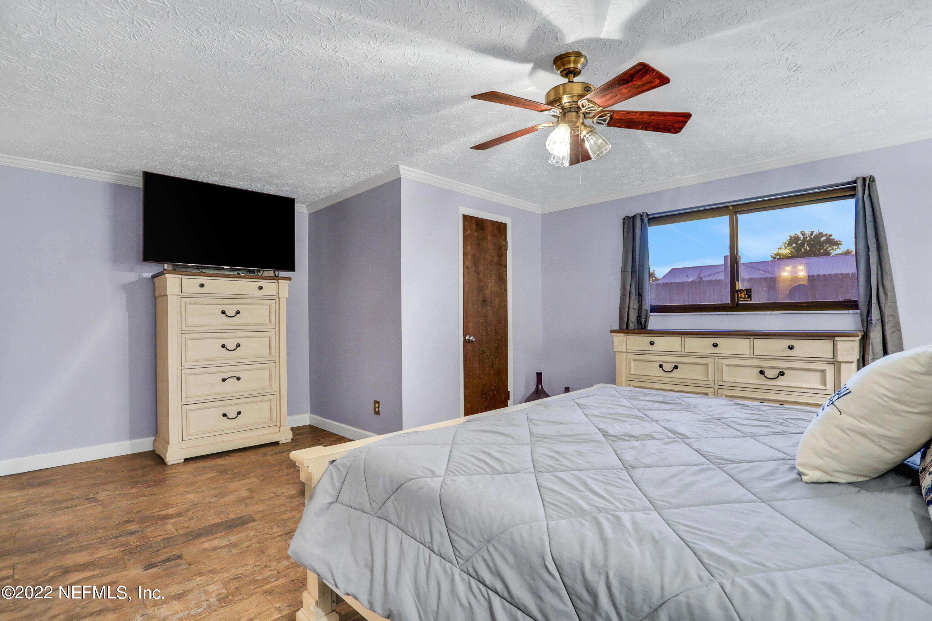 2198 Carter Braxton Road Orange Park, FL 32073 - Photo 25 of 33 a bedroom with a large bed and a flat screen tv
