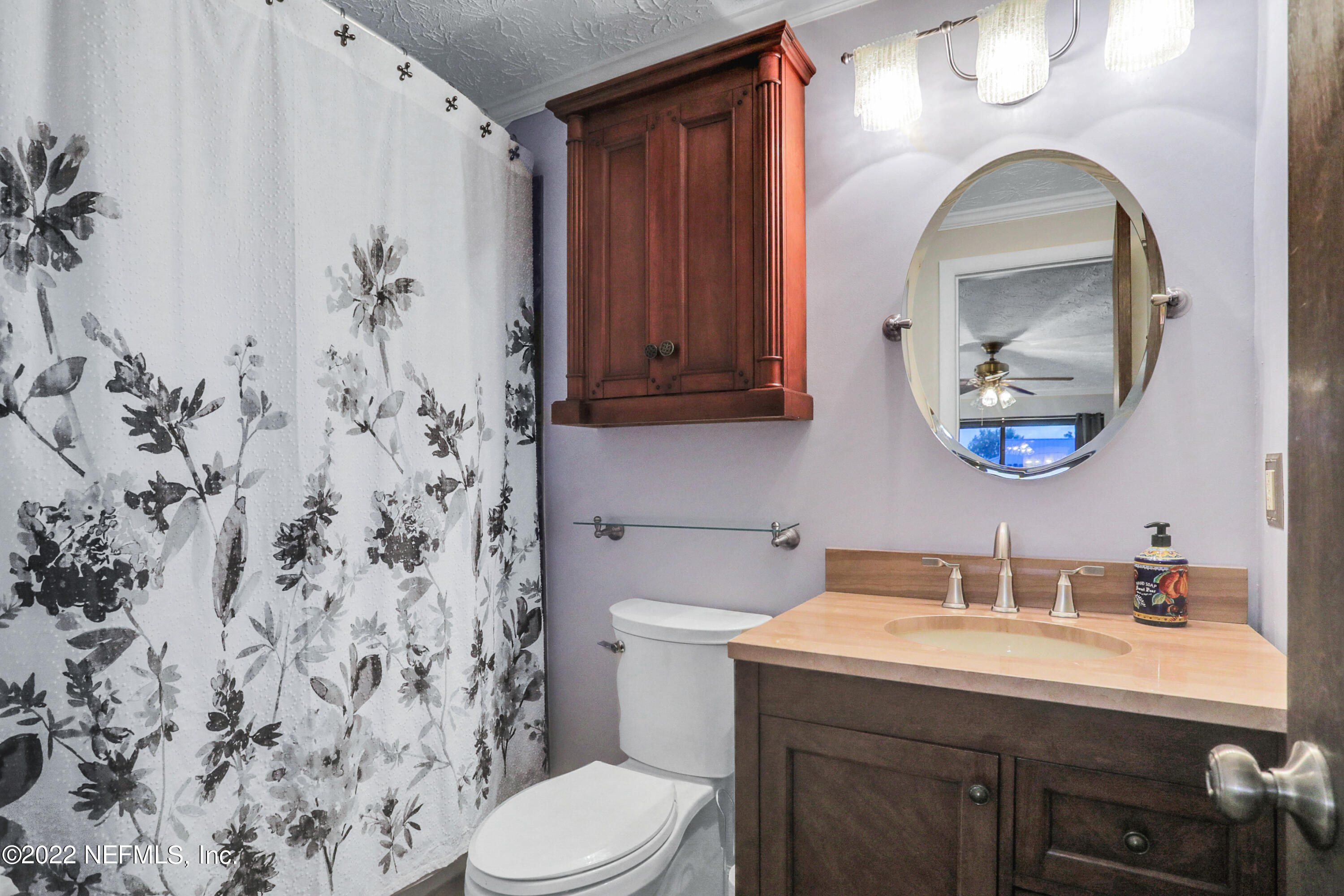 2198 Carter Braxton Road Orange Park, FL 32073 - Photo 27 of 33 a bathroom with a sink and a mirror
