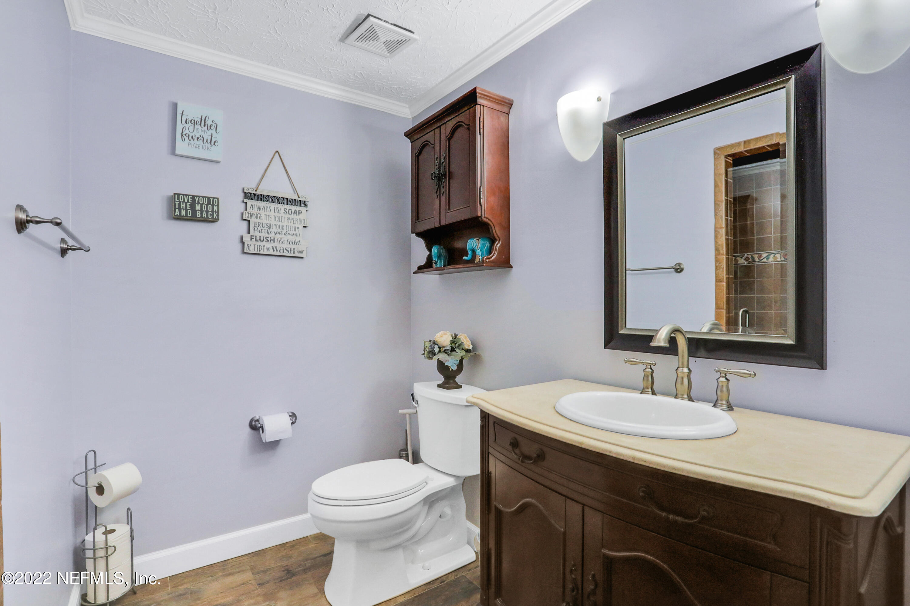 2198 Carter Braxton Road Orange Park, FL 32073 - Photo 31 of 33 a bathroom with a toilet a sink and mirror