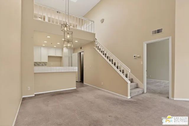 a view of staircase and kitchen with a window