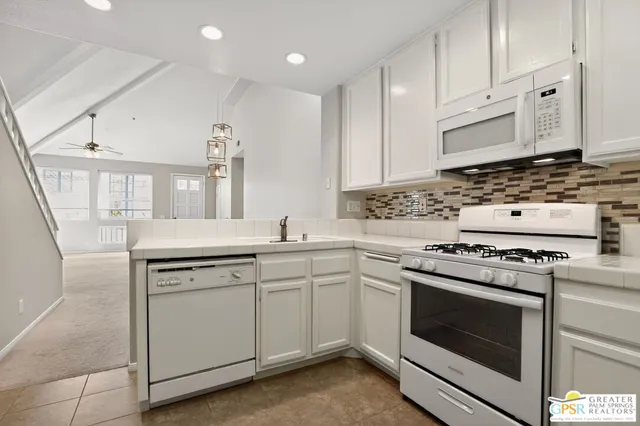 a kitchen with cabinets appliances and a sink
