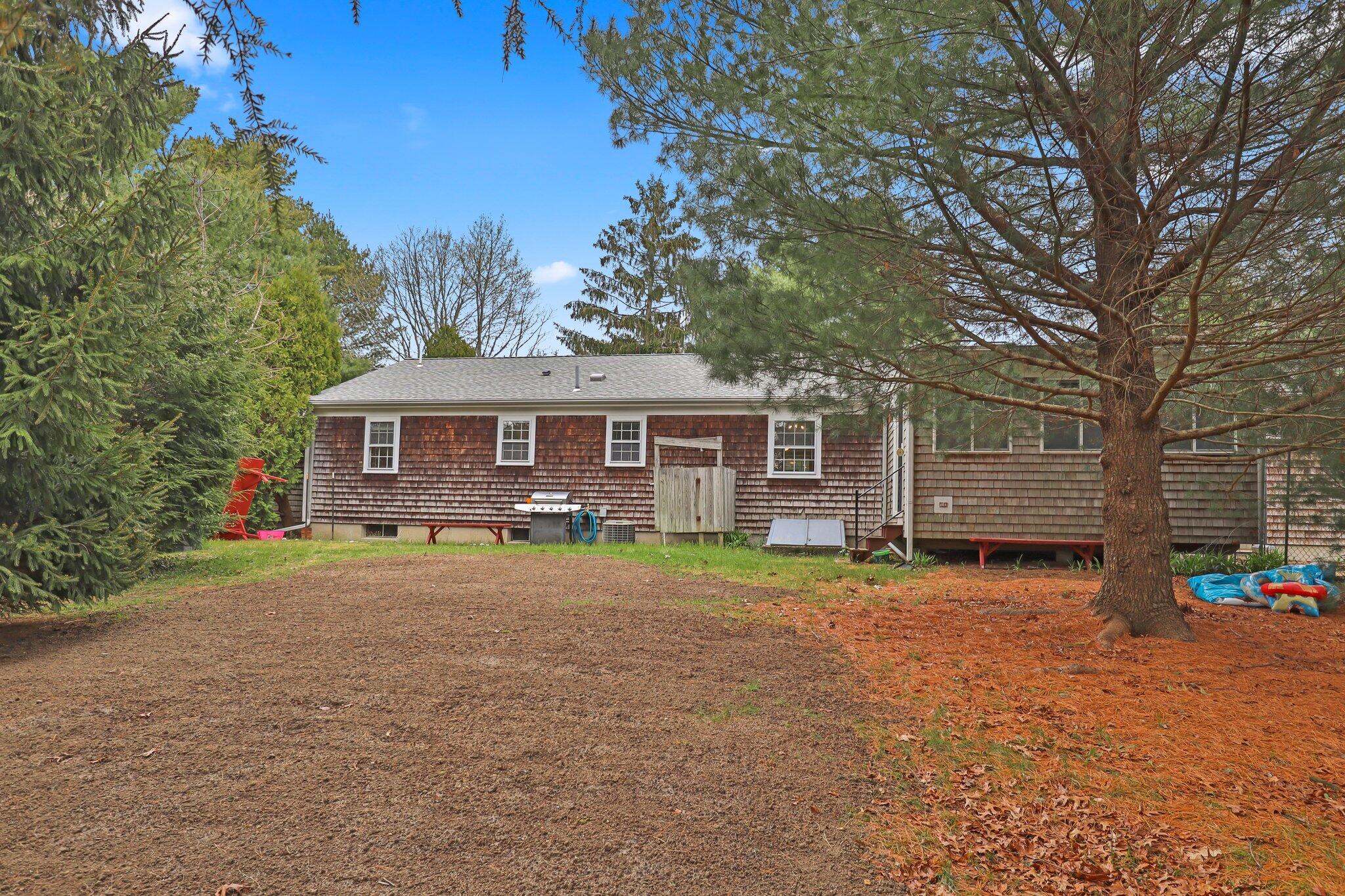 3 Lietrim Circle Centerville, MA 02632 - Photo 38 of 42 a front view of a house with a garden and trees