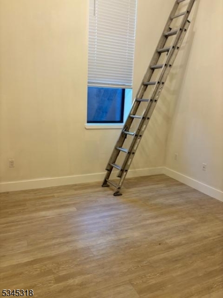 29 Broadway, Unit 2 3 Passaic, NJ 07055 - Photo 5 of 9 a view of an empty room with stairs