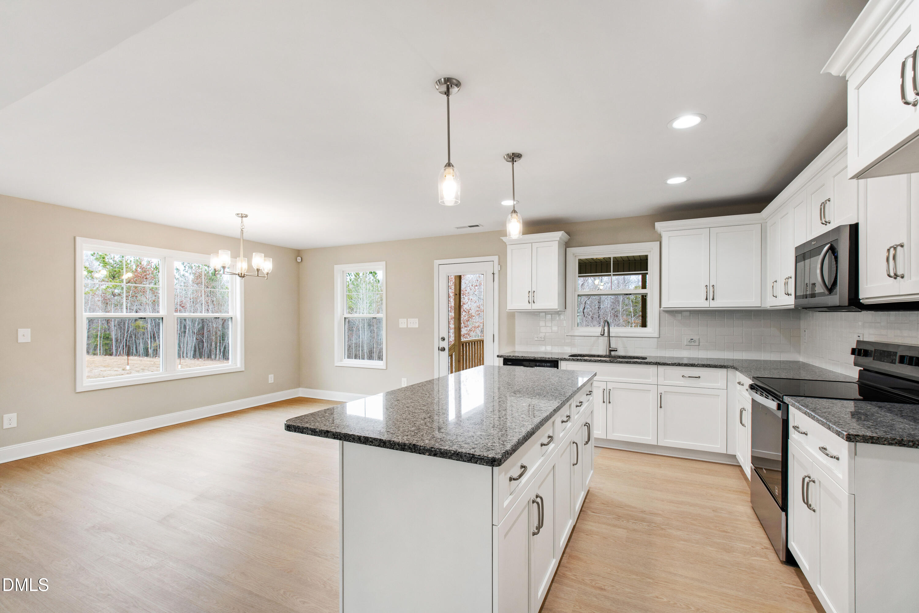 77 Falls Riv Court Broadway, NC 27505 - Photo 11 of 39 a large kitchen with stainless steel appliances granite countertop a sink stove and cabinets