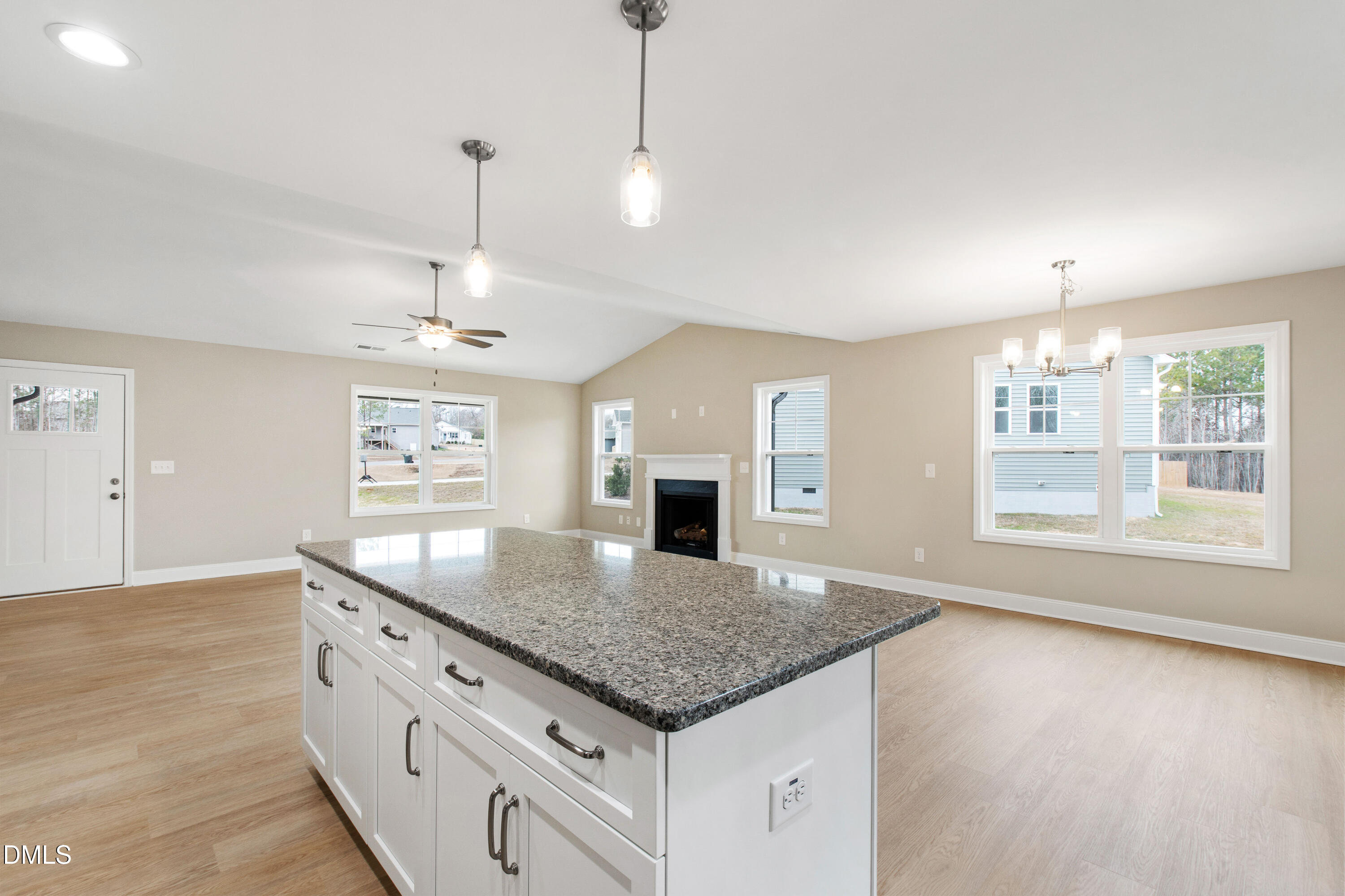 77 Falls Riv Court Broadway, NC 27505 - Photo 13 of 39 a kitchen with granite countertop a stove and a wooden floor