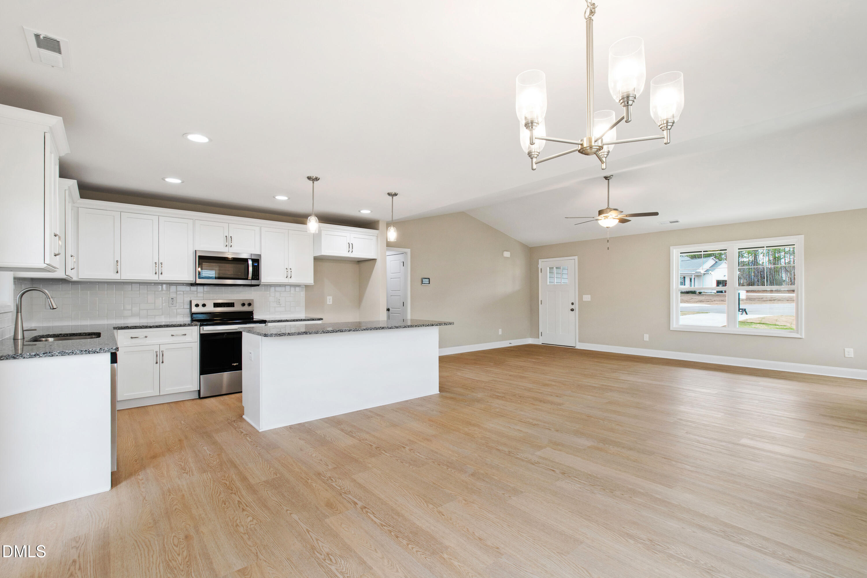 77 Falls Riv Court Broadway, NC 27505 - Photo 8 of 39 a large kitchen with stainless steel appliances kitchen island a large counter top and a wooden floor