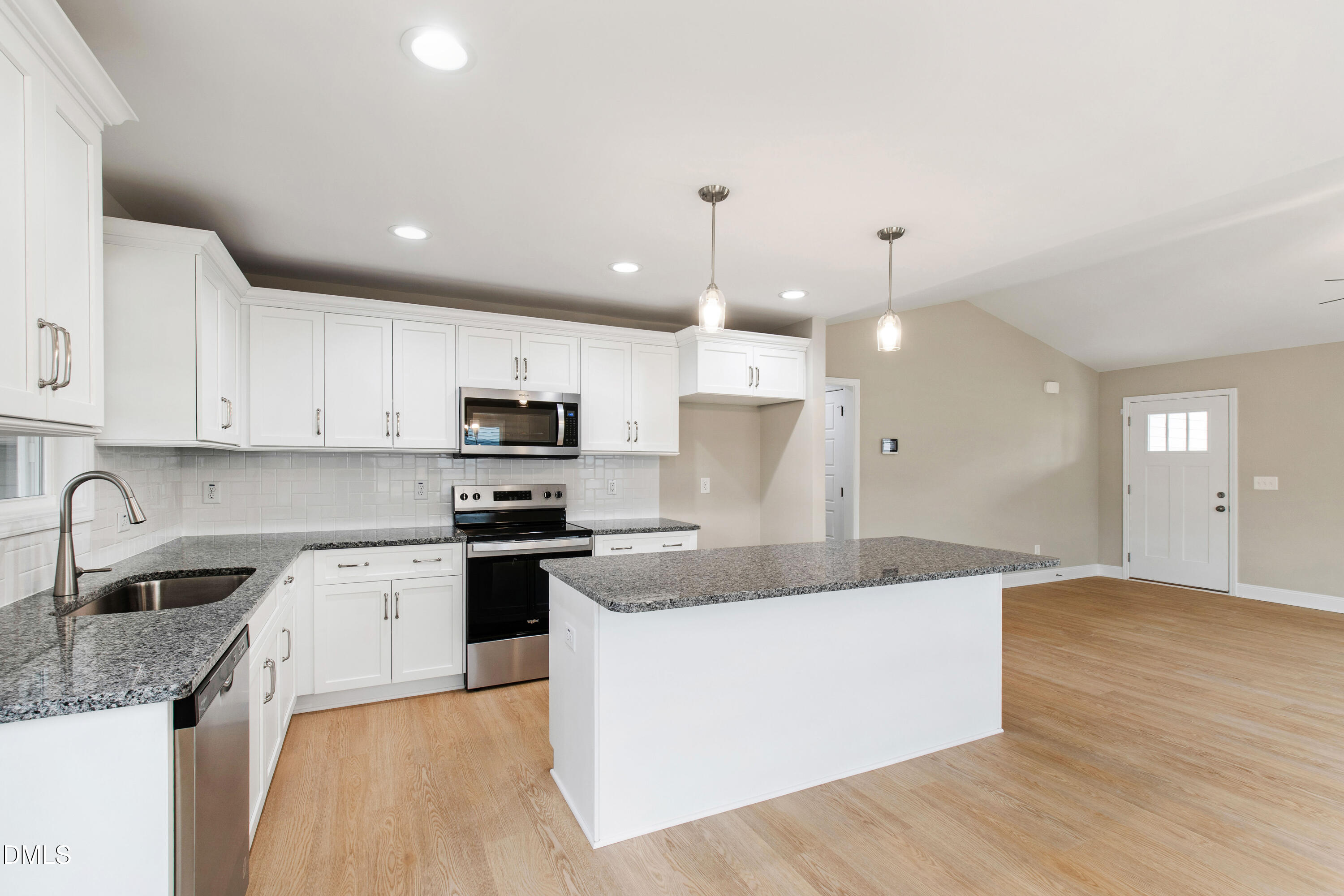 77 Falls Riv Court Broadway, NC 27505 - Photo 9 of 39 a large kitchen with granite countertop a white stove top oven a sink dishwasher and a refrigerator with wooden floor
