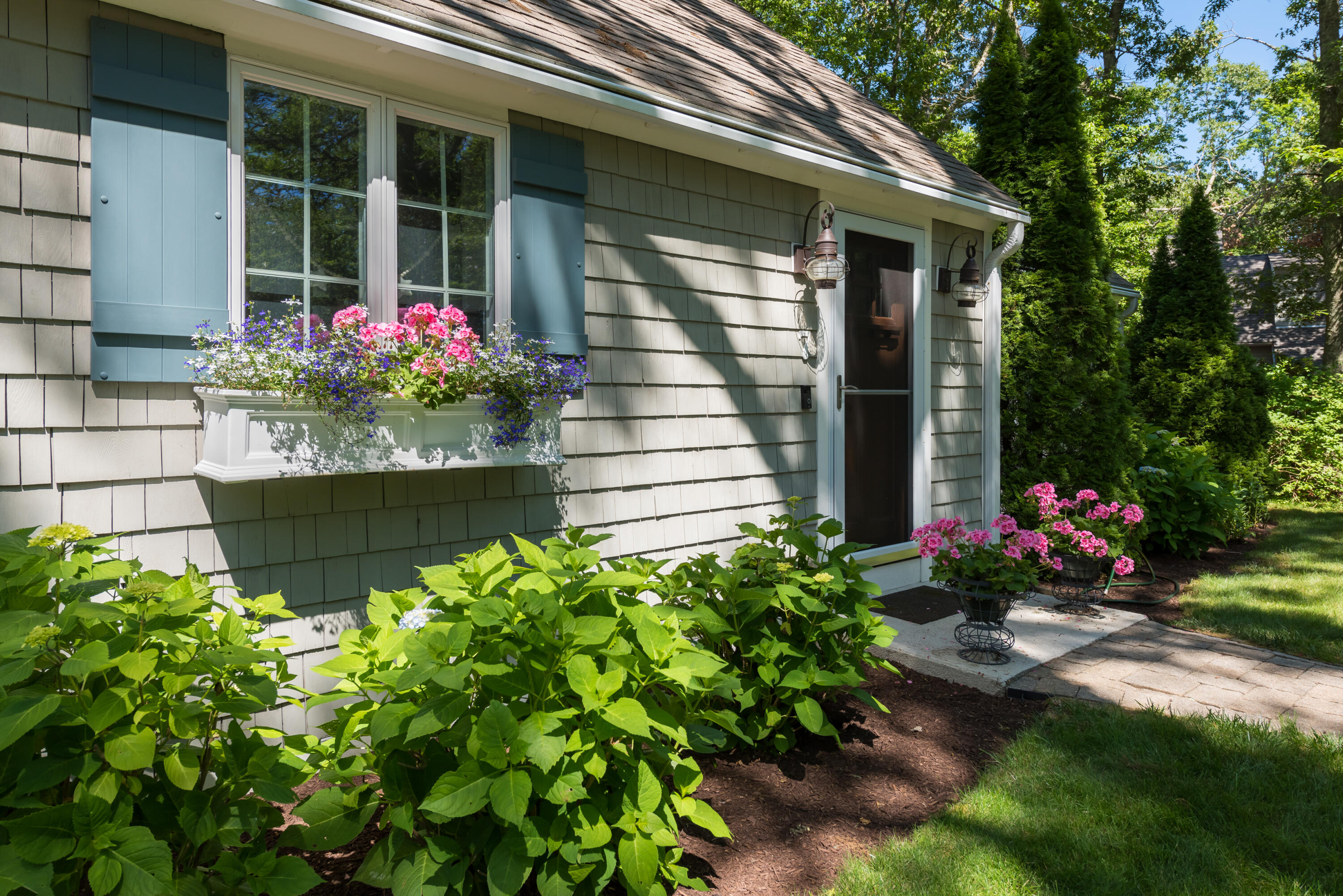 7 Sand Dollar Lane Mashpee, MA 02649 - Photo 2 of 33 a bunch of flowers in front of the house
