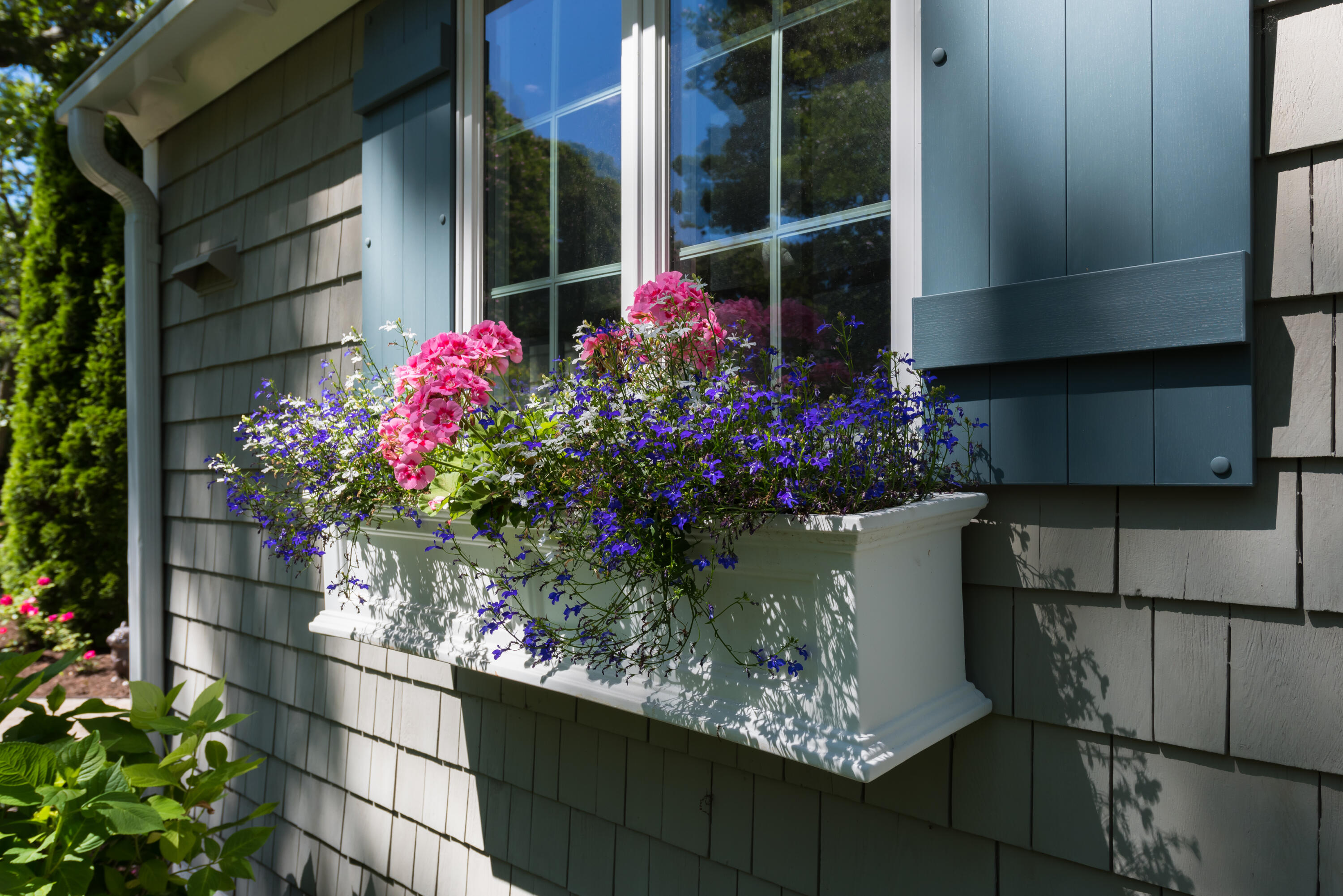 7 Sand Dollar Lane Mashpee, MA 02649 - Photo 3 of 33 a view of a wooden house with a flower garden