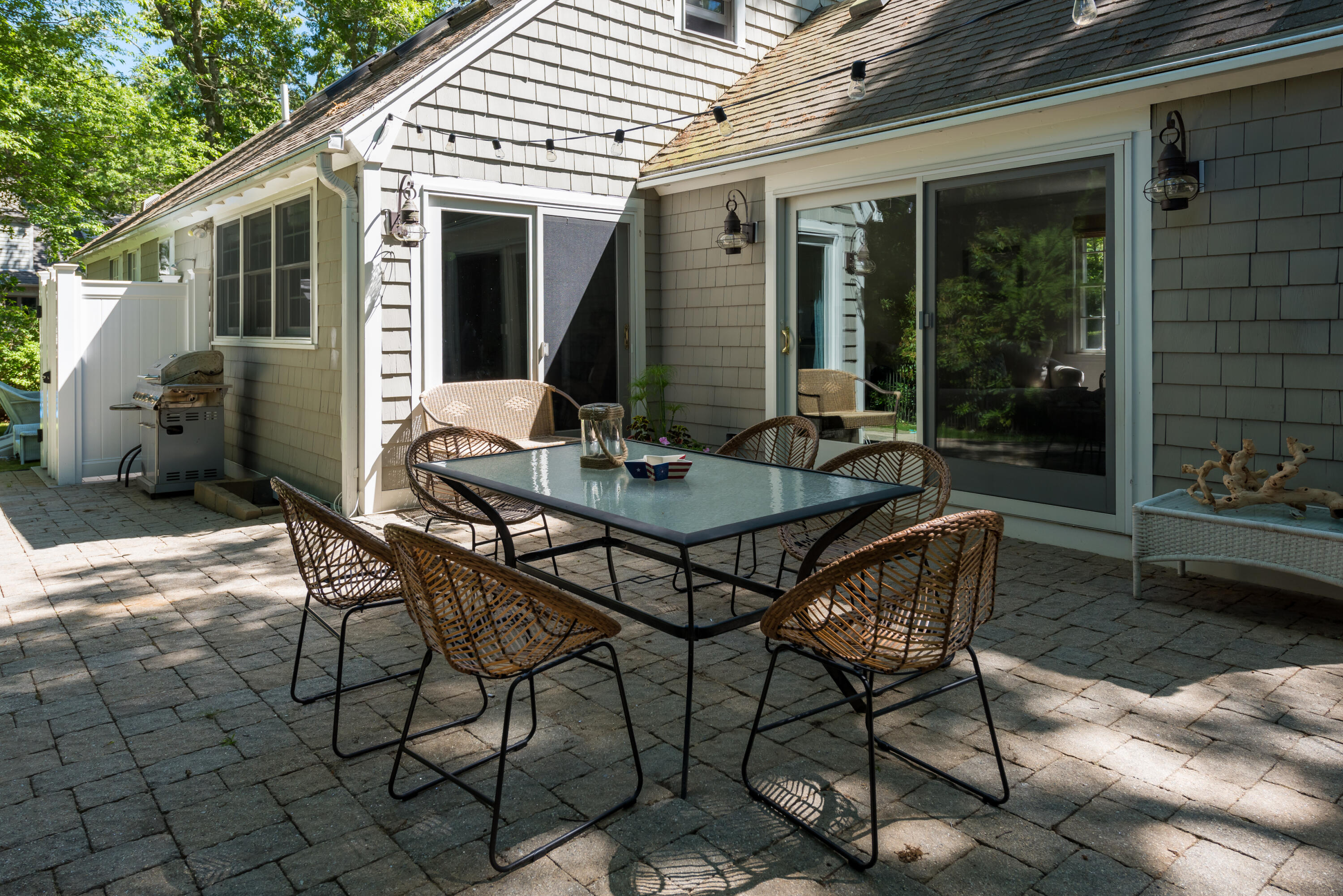 7 Sand Dollar Lane Mashpee, MA 02649 - Photo 32 of 33 a view of a patio with table and chairs and potted plants