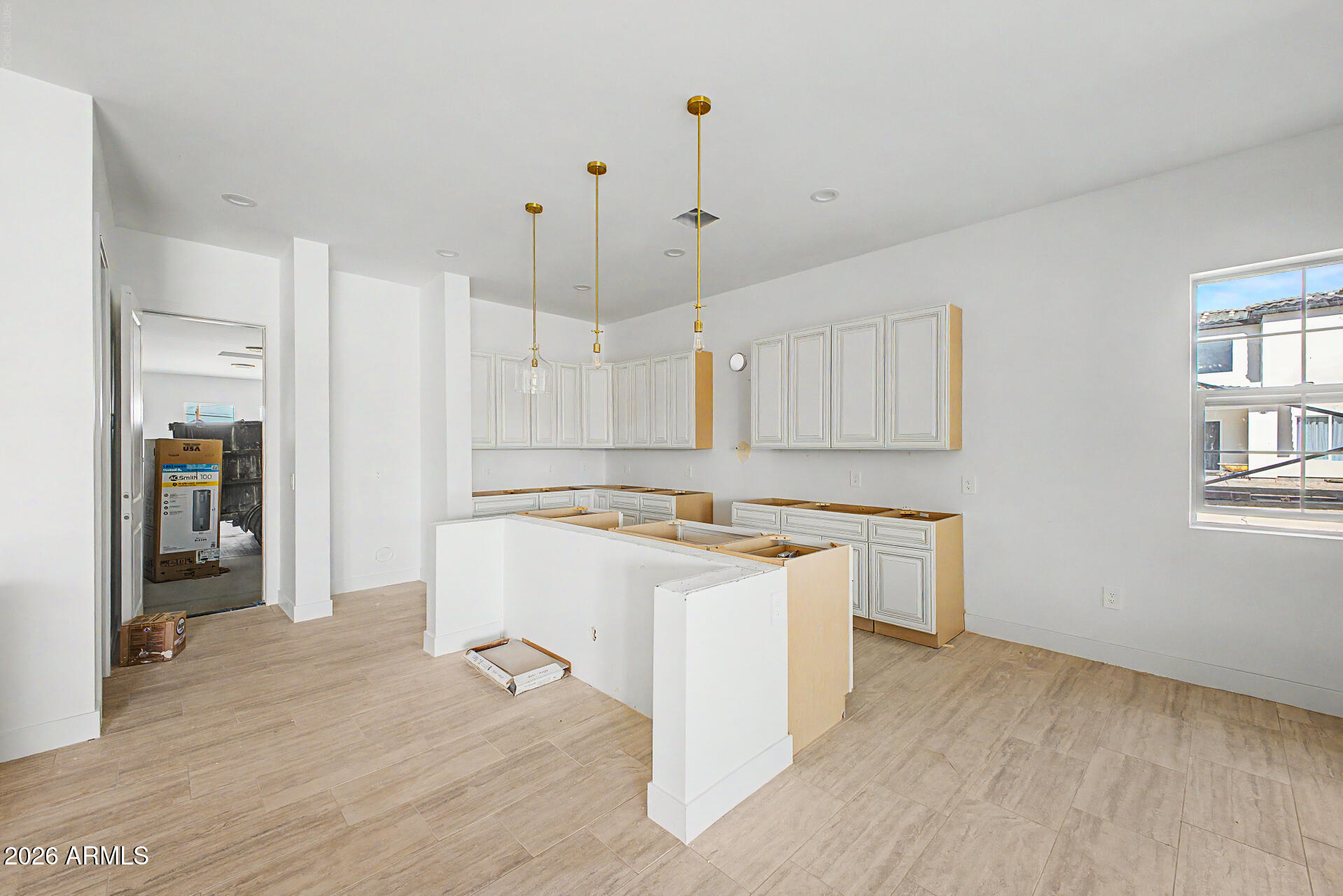 18815 West Arlington Road Buckeye, AZ 85326 - Photo 16 of 56 a room with kitchen island a sink stove and refrigerator