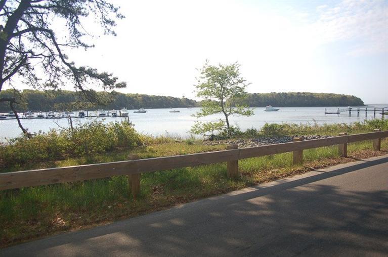 225 Simon Narrows Road Mashpee, MA 02649 - Photo 20 of 22 a view of a lake with a garden