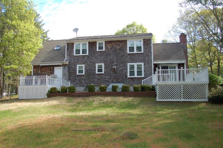 225 Simon Narrows Road Mashpee, MA 02649 - Photo 2 of 22 a front view of a house with a garden