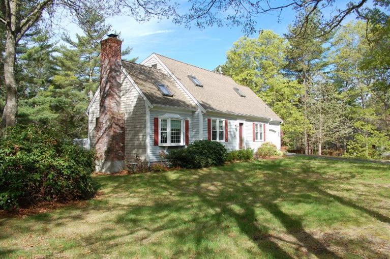 225 Simon Narrows Road Mashpee, MA 02649 - Photo 3 of 22 a view of a house next to a big yard and large trees